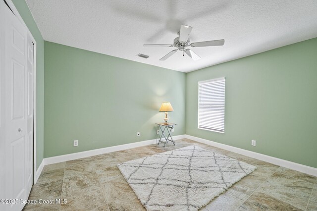1317 Mohegan Ter SE, Palm Bay, FL 32909 - unfurnished room featuring ceiling fan, a textured ceiling, and baseboards