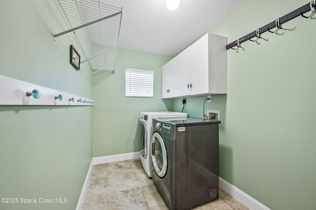 1317 Mohegan Ter SE, Palm Bay, FL 32909 - laundry area with washing machine and clothes dryer, baseboards, cabinet space, and a textured ceiling