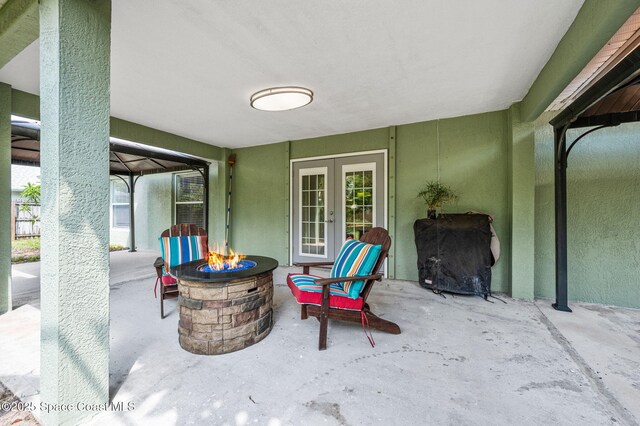1317 Mohegan Ter SE, Palm Bay, FL 32909 - view of patio / terrace featuring a fire pit, french doors, and grilling area