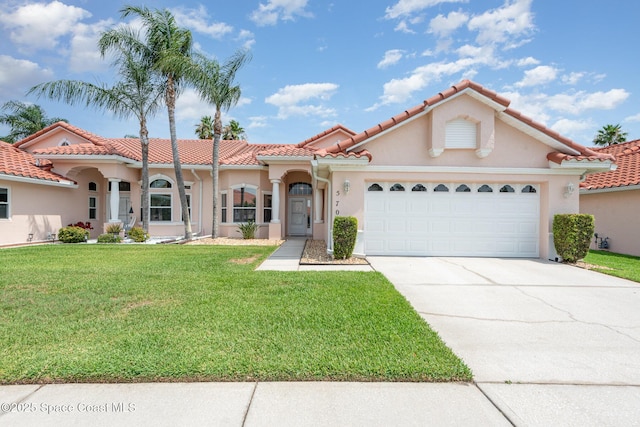 570 Shell Cove Dr, Melbourne, FL 32940 - mediterranean / spanish-style house with a front yard, driveway, an attached garage, and stucco siding