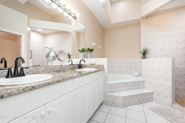 570 Shell Cove Dr, Melbourne, FL 32940 - bathroom featuring tile patterned flooring, double vanity, and a garden tub