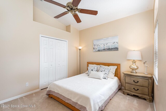 570 Shell Cove Dr, Melbourne, FL 32940 - bedroom featuring light carpet, a closet, lofted ceiling, baseboards, and a ceiling fan