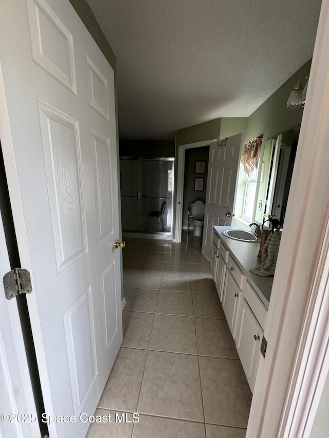 157 Lehigh Ave SE, Palm Bay, FL 32909 - bathroom featuring vanity, toilet, tile patterned floors, and a textured ceiling