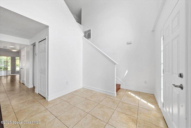 1500 La Maderia Dr SW, Palm Bay, FL 32908 - foyer featuring stairs, light tile patterned floors, and baseboards