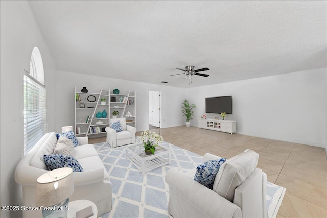 1500 La Maderia Dr SW, Palm Bay, FL 32908 - living area featuring ceiling fan, tile patterned floors, a textured ceiling, and baseboards