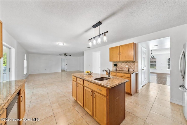 1500 La Maderia Dr SW, Palm Bay, FL 32908 - kitchen featuring a sink, light tile patterned floors, decorative backsplash, ceiling fan, and light stone countertops
