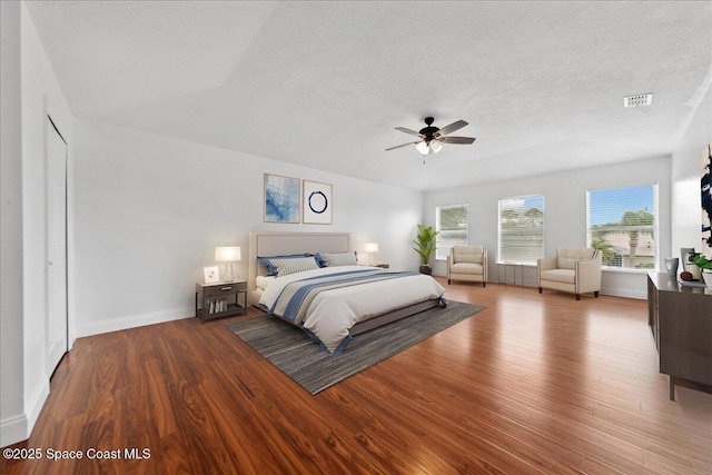 1500 La Maderia Dr SW, Palm Bay, FL 32908 - bedroom with wood finished floors, a textured ceiling, baseboards, and ceiling fan