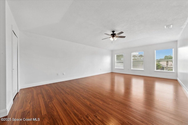 1500 La Maderia Dr SW, Palm Bay, FL 32908 - empty room featuring wood finished floors, a ceiling fan, baseboards, and a textured ceiling
