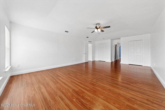 1500 La Maderia Dr SW, Palm Bay, FL 32908 - empty room featuring ceiling fan, wood finished floors, arched walkways, and baseboards