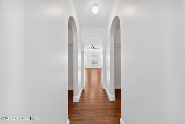 1500 La Maderia Dr SW, Palm Bay, FL 32908 - corridor featuring arched walkways, wood finished floors, and baseboards