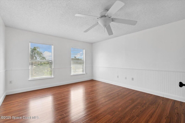 1500 La Maderia Dr SW, Palm Bay, FL 32908 - unfurnished room featuring wood finished floors, a textured ceiling, ceiling fan, and a wainscoted wall