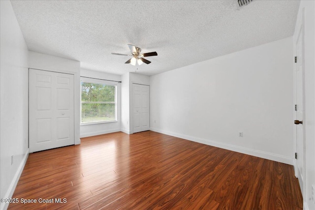 1500 La Maderia Dr SW, Palm Bay, FL 32908 - unfurnished bedroom with wood finished floors, a textured ceiling, baseboards, and a ceiling fan