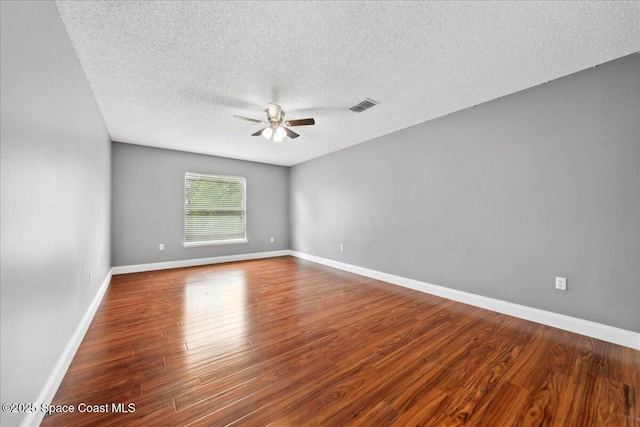 1500 La Maderia Dr SW, Palm Bay, FL 32908 - empty room with a ceiling fan, a textured ceiling, wood finished floors, and baseboards