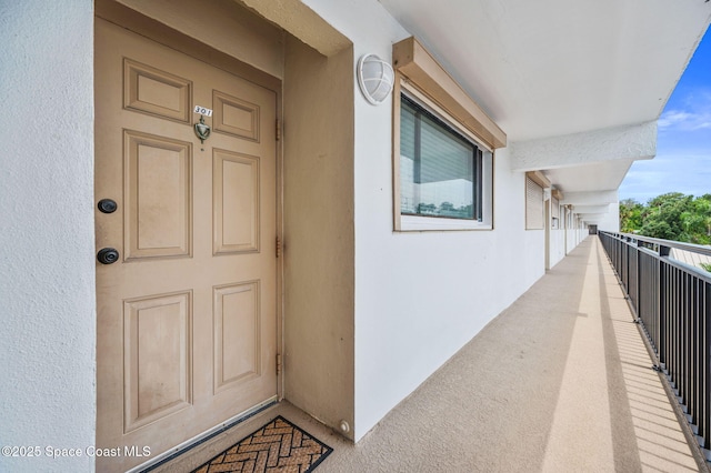 3901 Dixie Hwy NE Unit 301, Palm Bay, FL 32905 - doorway to property with stucco siding and a balcony