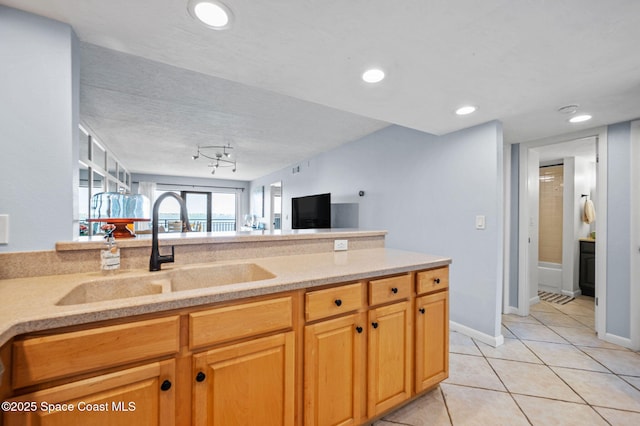 3901 Dixie Hwy NE Unit 301, Palm Bay, FL 32905 - kitchen with a sink, light tile patterned flooring, recessed lighting, open floor plan, and light stone countertops