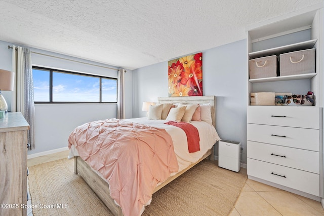 3901 Dixie Hwy NE Unit 301, Palm Bay, FL 32905 - bedroom with light tile patterned floors and a textured ceiling