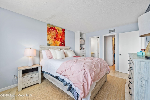 3901 Dixie Hwy NE Unit 301, Palm Bay, FL 32905 - bedroom with a textured ceiling, light tile patterned floors, and baseboards