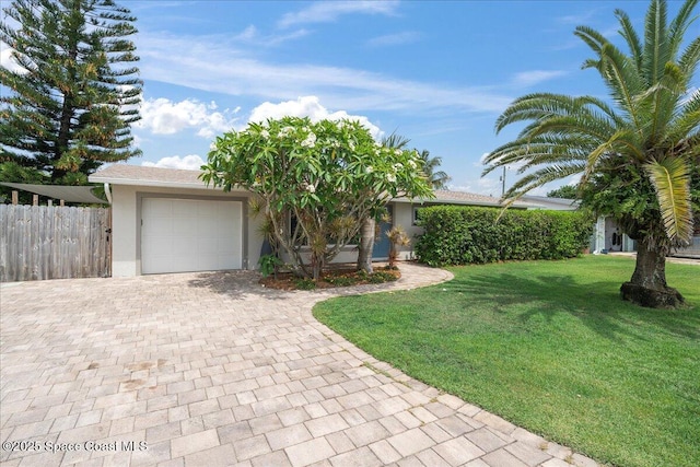 629 Verbenia Dr, Satellite Beach, FL 32937 - view of front of property with decorative driveway, an attached garage, and stucco siding