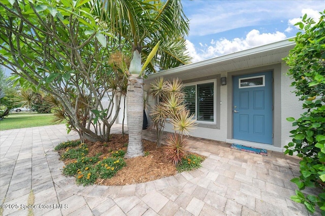 629 Verbenia Dr, Satellite Beach, FL 32937 - view of exterior entry featuring stucco siding