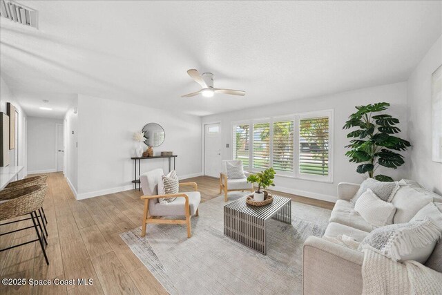 629 Verbenia Dr, Satellite Beach, FL 32937 - living room with wood finished floors, ceiling fan, and baseboards