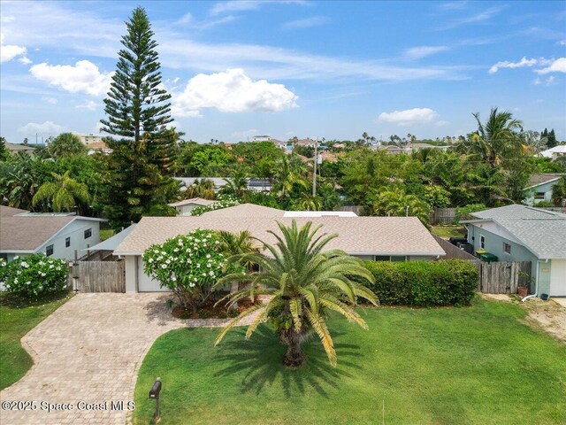 629 Verbenia Dr, Satellite Beach, FL 32937 - view of front of home featuring decorative driveway, an attached garage, and a residential view