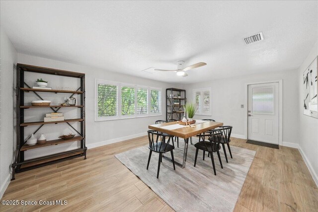 629 Verbenia Dr, Satellite Beach, FL 32937 - dining room with light wood finished floors, baseboards, and ceiling fan