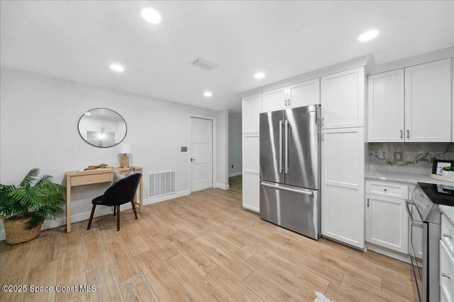 629 Verbenia Dr, Satellite Beach, FL 32937 - kitchen featuring stainless steel appliances, light wood-type flooring, white cabinets, recessed lighting, and tasteful backsplash