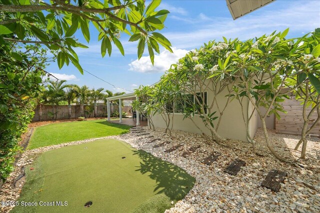 629 Verbenia Dr, Satellite Beach, FL 32937 - view of yard featuring a putting area and a patio