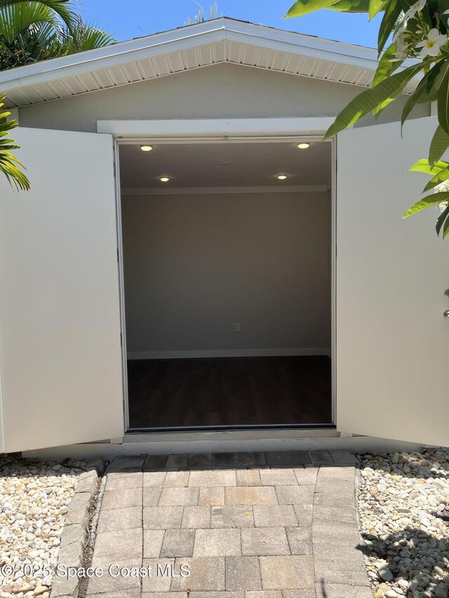 629 Verbenia Dr, Satellite Beach, FL 32937 - doorway to property featuring stucco siding