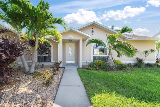 1911 Crane Creek Blvd, Melbourne, FL 32940 - view of front of property featuring stucco siding and a front lawn