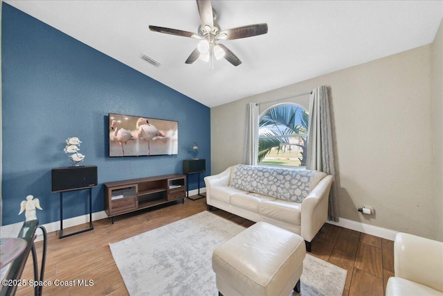 1911 Crane Creek Blvd, Melbourne, FL 32940 - living room with lofted ceiling, ceiling fan, wood finished floors, and baseboards