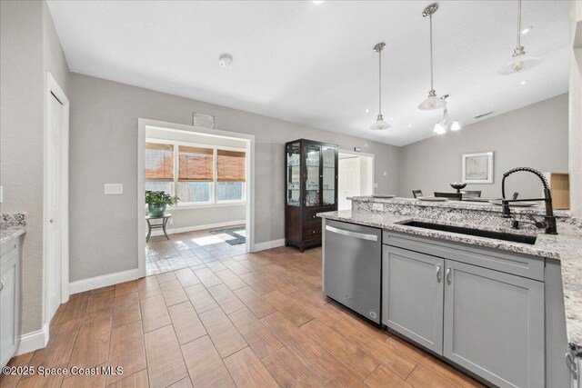 1911 Crane Creek Blvd, Melbourne, FL 32940 - kitchen with dishwasher, gray cabinetry, a sink, a peninsula, and baseboards