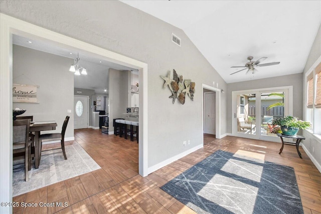 1911 Crane Creek Blvd, Melbourne, FL 32940 - entryway featuring vaulted ceiling, wood finished floors, a ceiling fan, baseboards, and a chandelier