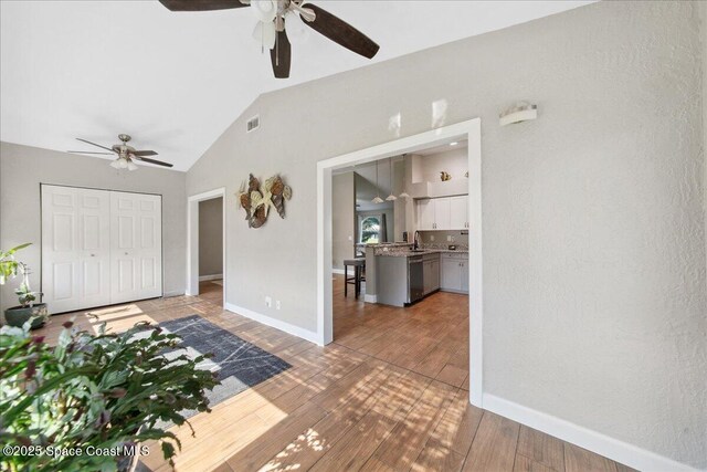 1911 Crane Creek Blvd, Melbourne, FL 32940 - foyer featuring a ceiling fan, lofted ceiling, wood finished floors, and baseboards