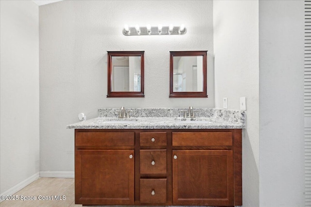 1911 Crane Creek Blvd, Melbourne, FL 32940 - bathroom featuring double vanity and baseboards