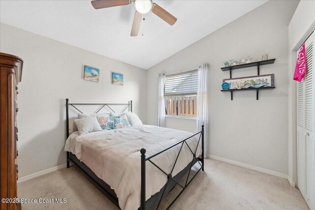 1911 Crane Creek Blvd, Melbourne, FL 32940 - bedroom with light carpet, vaulted ceiling, baseboards, and ceiling fan
