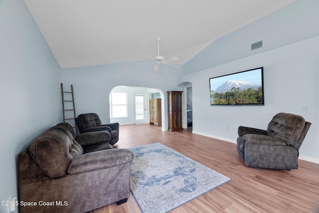 1685 Timacuan Dr, Melbourne, FL 32940 - living room with arched walkways, lofted ceiling, light wood-style flooring, baseboards, and a ceiling fan