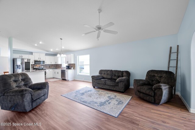 1685 Timacuan Dr, Melbourne, FL 32940 - living area featuring lofted ceiling, light wood-style flooring, a ceiling fan, baseboards, and recessed lighting