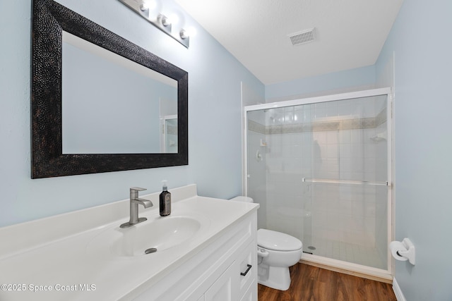 1685 Timacuan Dr, Melbourne, FL 32940 - full bathroom with toilet, vanity, wood finished floors, and a shower stall