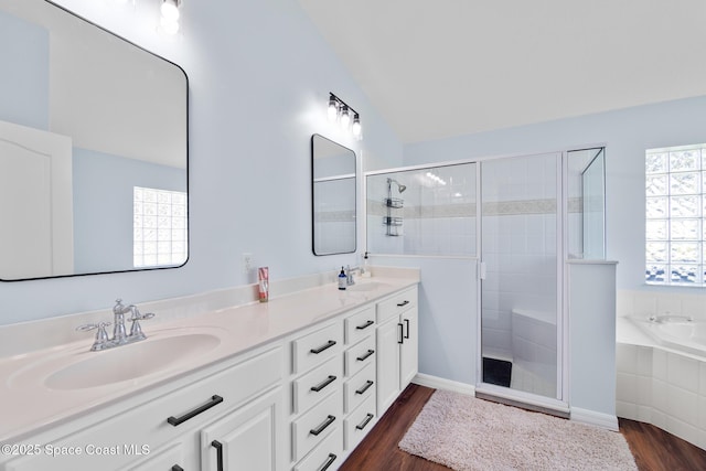 1685 Timacuan Dr, Melbourne, FL 32940 - full bath with wood finished floors, double vanity, a stall shower, a garden tub, and vaulted ceiling