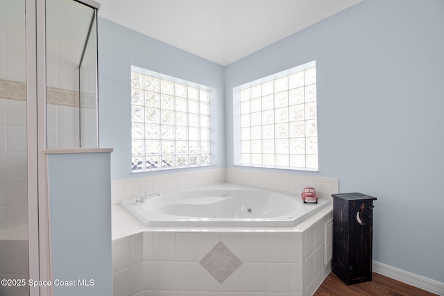 1685 Timacuan Dr, Melbourne, FL 32940 - full bathroom featuring a whirlpool tub and wood finished floors