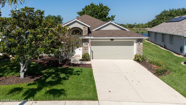 1685 Timacuan Dr, Melbourne, FL 32940 - view of front of house featuring stone siding, a front yard, a garage, driveway, and roof with shingles