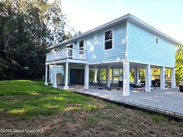 9470 Hibiscus Ave, Sebastian, FL 32976 - rear view of property with a carport, a patio, and a balcony