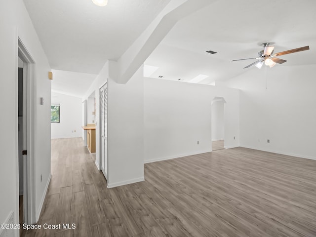 175 Awin Cir SE, Palm Bay, FL 32909 - empty room with lofted ceiling, wood finished floors, ceiling fan, and baseboards