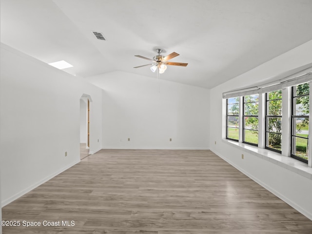 175 Awin Cir SE, Palm Bay, FL 32909 - spare room featuring vaulted ceiling, a ceiling fan, wood finished floors, and baseboards