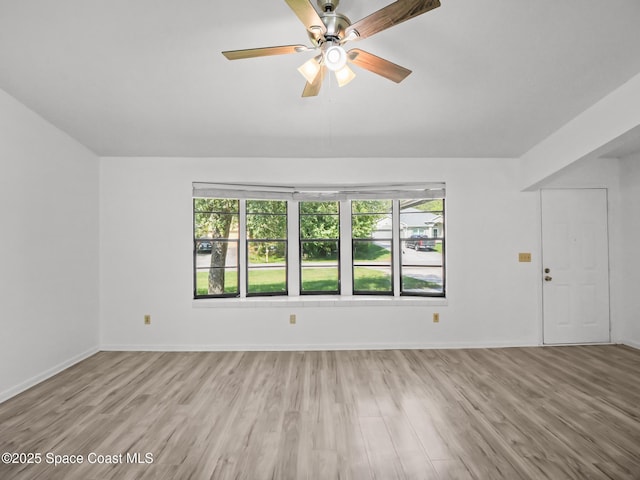 175 Awin Cir SE, Palm Bay, FL 32909 - unfurnished living room with healthy amount of natural light, wood finished floors, and baseboards