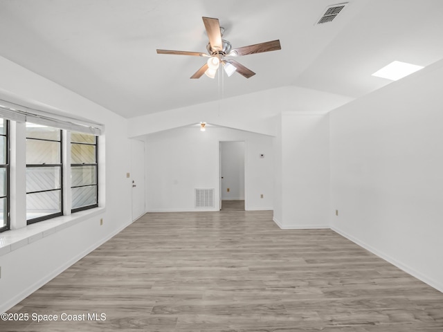 175 Awin Cir SE, Palm Bay, FL 32909 - unfurnished living room with lofted ceiling, a ceiling fan, wood finished floors, and baseboards