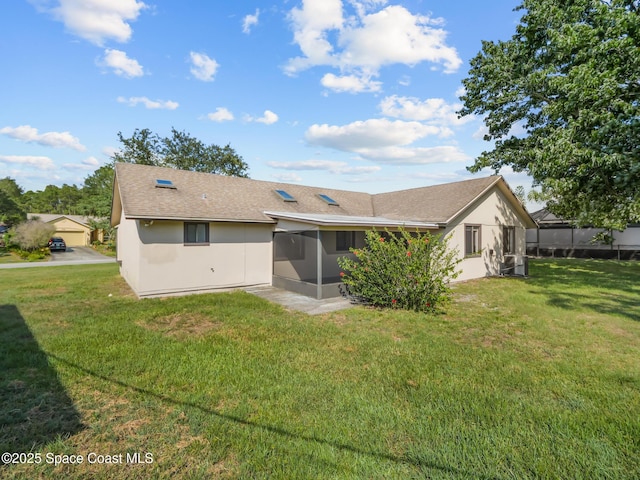 175 Awin Cir SE, Palm Bay, FL 32909 - rear view of house featuring a sunroom, a yard, roof with shingles, and stucco siding