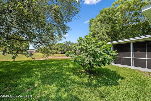 2719 Alicia Ln, Melbourne, FL 32935 - view of grassy yard with a sunroom
