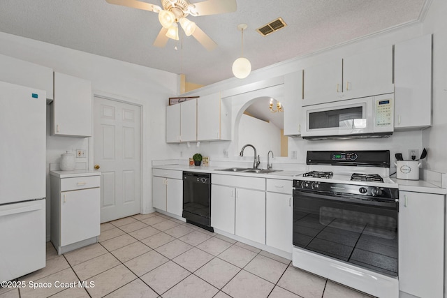 2719 Alicia Ln, Melbourne, FL 32935 - kitchen featuring white appliances, a sink, arched walkways, light countertops, and a textured ceiling